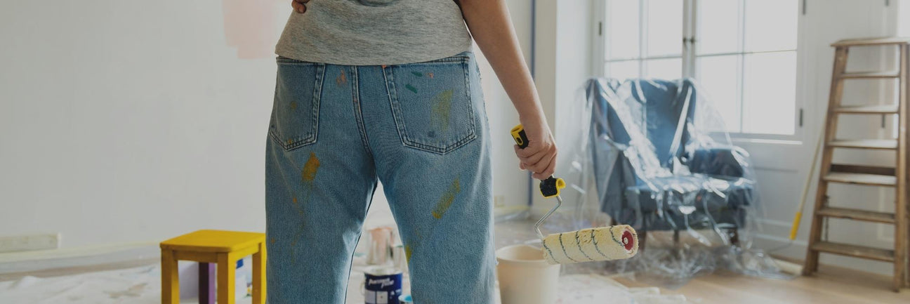 Woman standing in living room surrounded by DIY tools