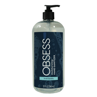 Clear 31 oz bottle with black pump dispenser lid and navy blue label saying "OBSESS moisturizing hand sanitizer fresh laundry"