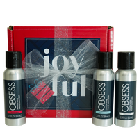 Red box with navy blue card saying Tis The Season To Be Joyful. Red box is wrapped in a glittery silver ribbon with a bow. Three 2.7 oz hand sanitzers are displayed next to the wrapped gift in the scents peppermint, fresh laundry and unscented.