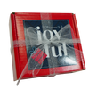 Red box with navy blue card saying Tis The Season To Be Joyful. Red box is wrapped in a glittery silver ribbon with a bow.